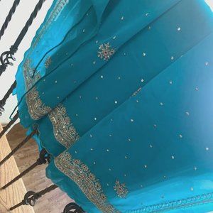 Teal colored synthetic embroidered chiffon Sari, halter blouse w/ fall & piko